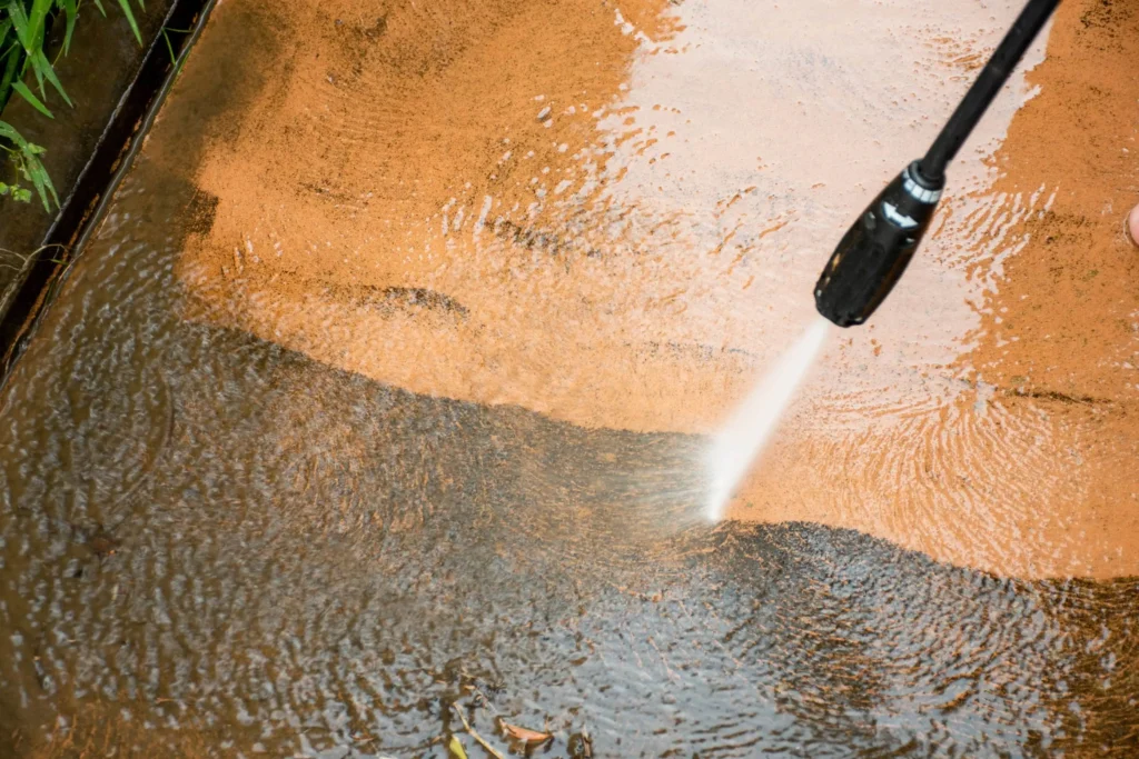 soft wash vs pressure wash - cleaning backyard with pressure washer cleaner